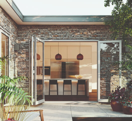 Duco folding doors in white opening onto a deck