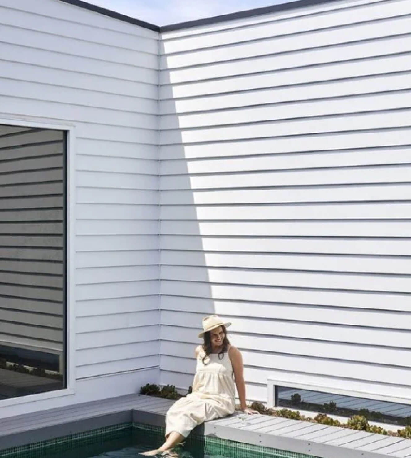 Duco - image of person sitting near a pool with large picture window