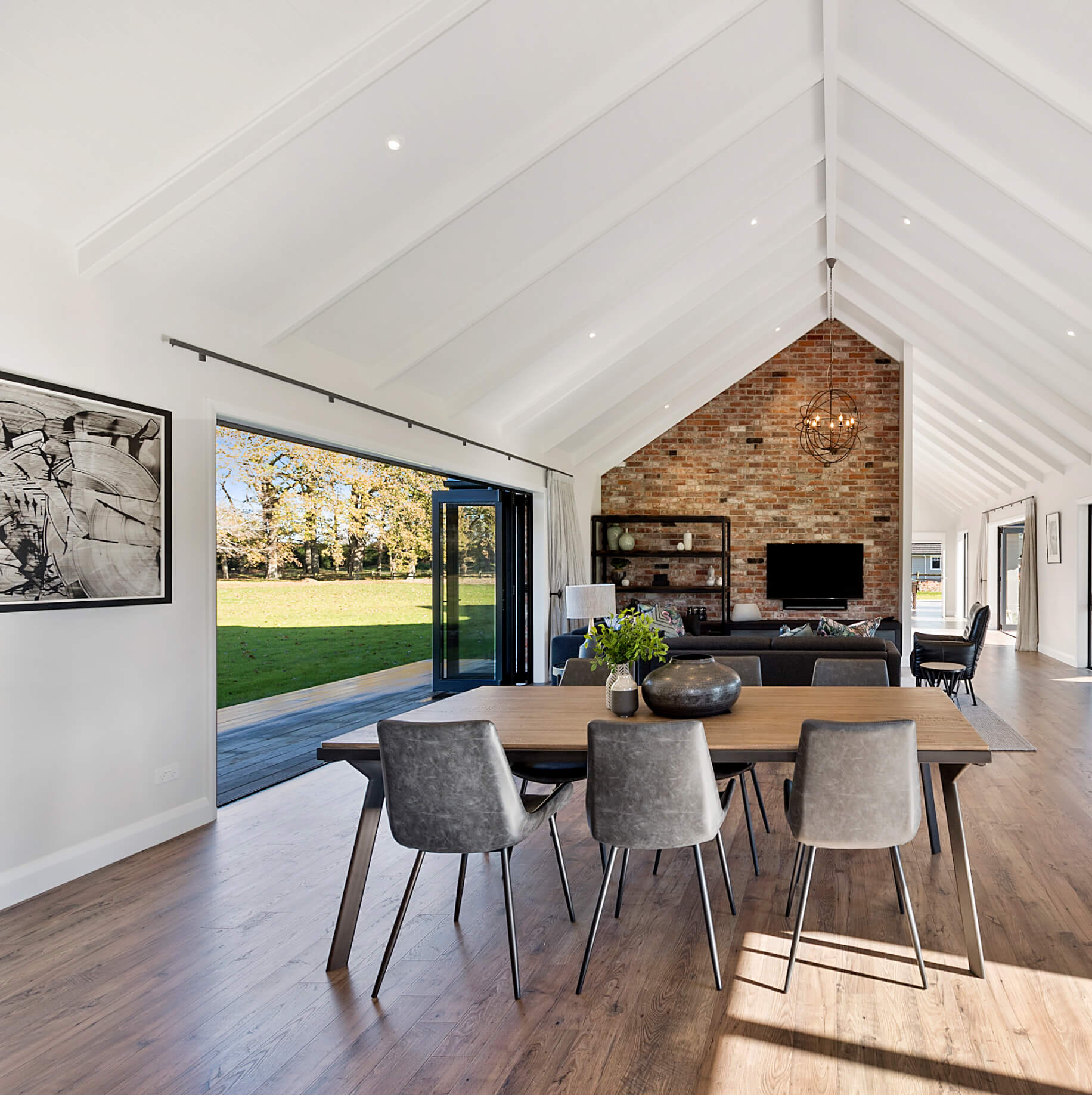 Duco folding doors in black opening onto a lawn