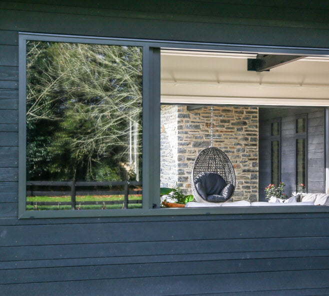 Duco sliding window - in a grey finish with a view to the garden