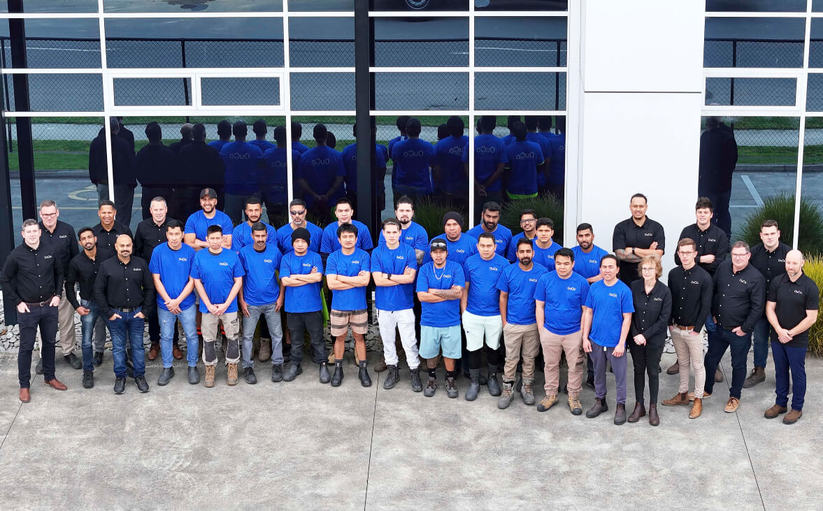 Duco image of the whole team standing outside the workplace