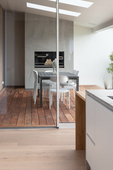 Duco Ceiling to floor sliding doors opening onto a deck in a house setting