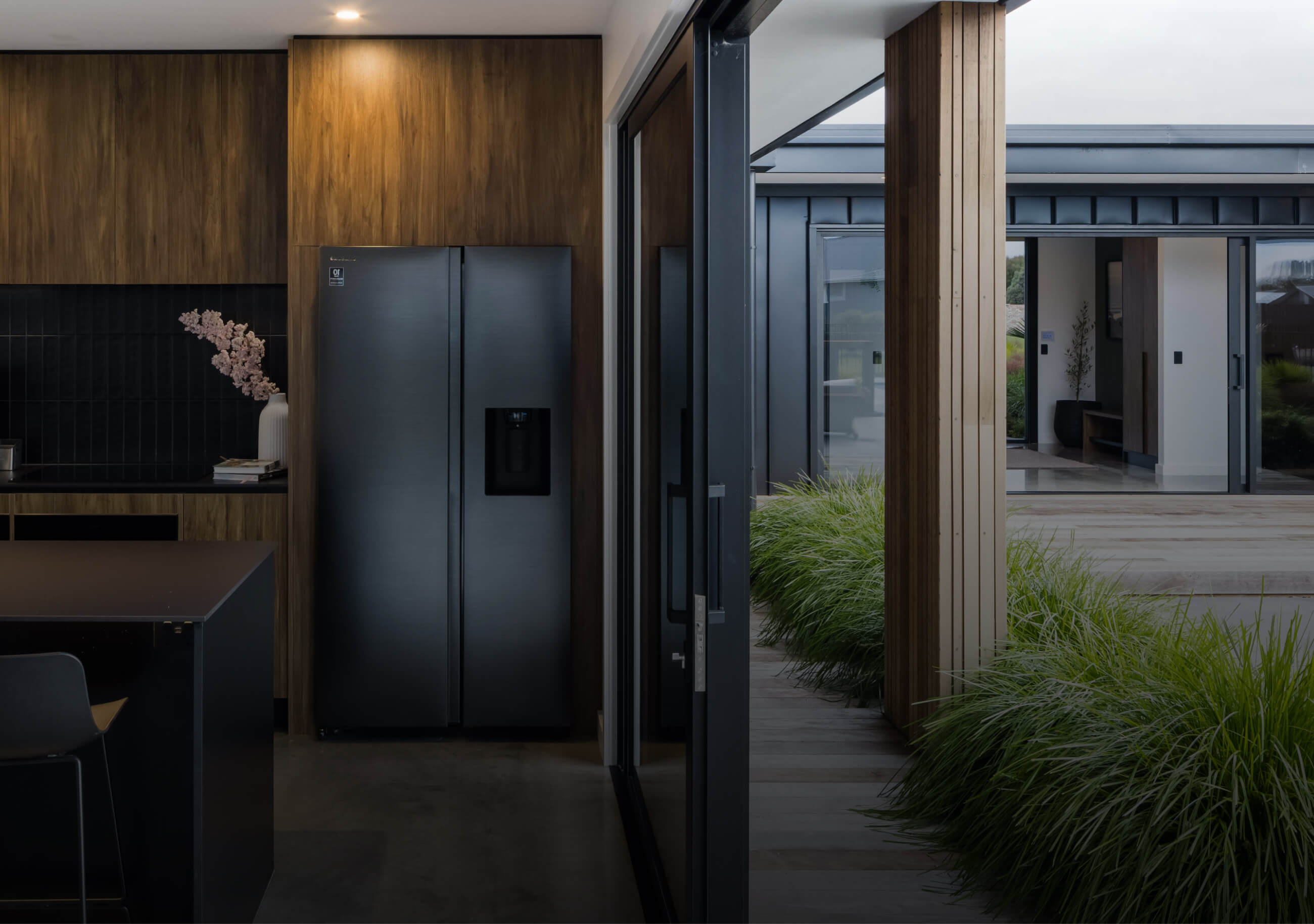 Duco ceiling to floor sliding doors displayed in a kitchen and deck setting