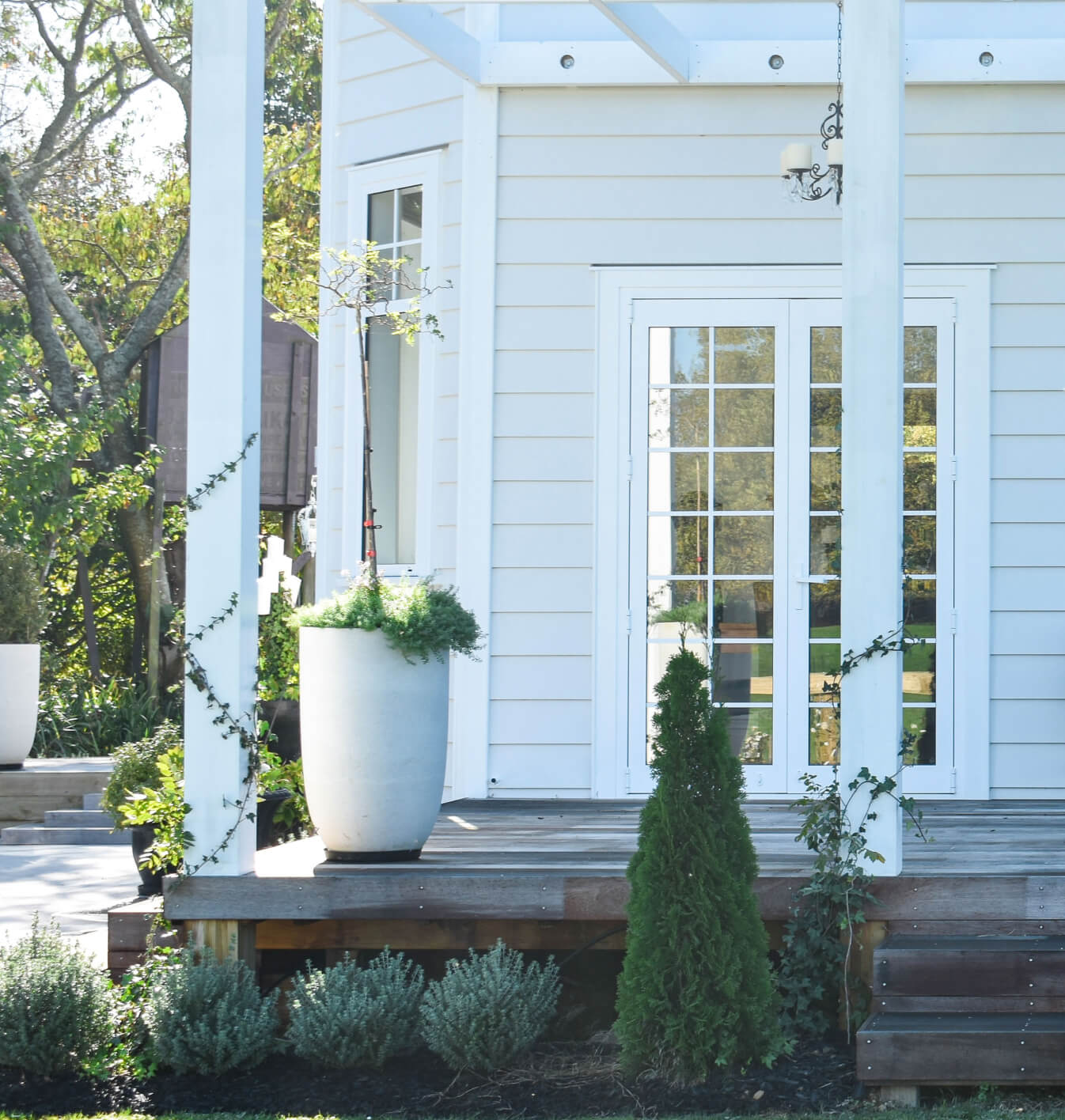 Duco door white with glass square panels onto a deck in a house setting